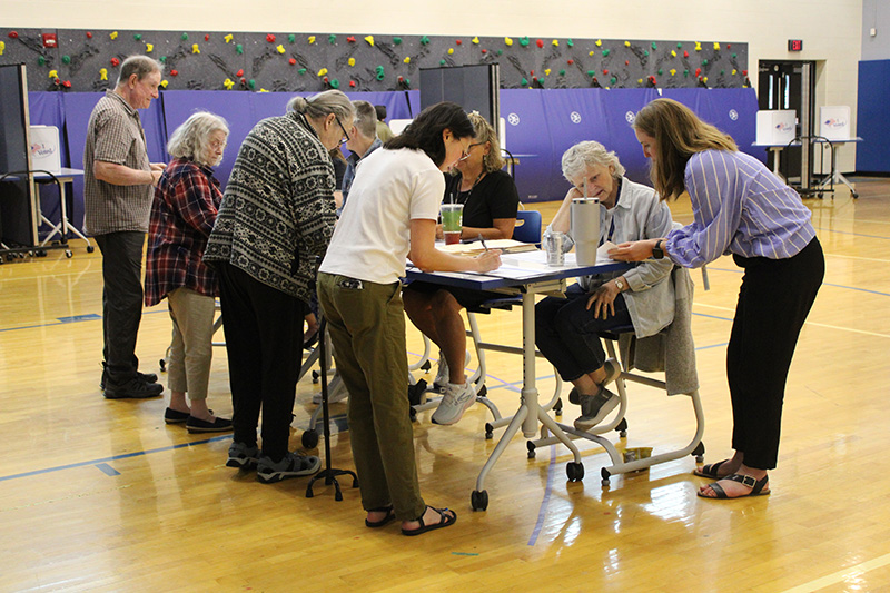Several voters sign in at the front table to vote on the revised school budget June 17.